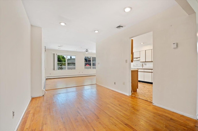 20 Deb St, Plainview, NY 11803 - unfurnished living room with a ceiling fan, light wood-style flooring, recessed lighting, and a baseboard heating unit