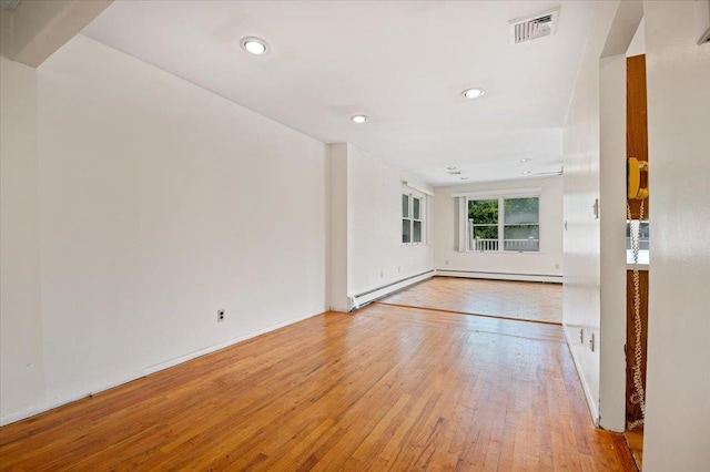 20 Deb St, Plainview, NY 11803 - spare room with light wood-type flooring, recessed lighting, a baseboard heating unit, and baseboard heating
