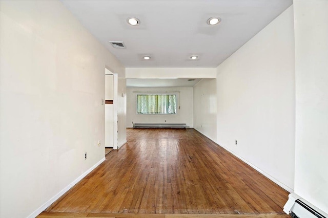 20 Deb St, Plainview, NY 11803 - unfurnished room with baseboard heating, a baseboard radiator, wood finished floors, and recessed lighting