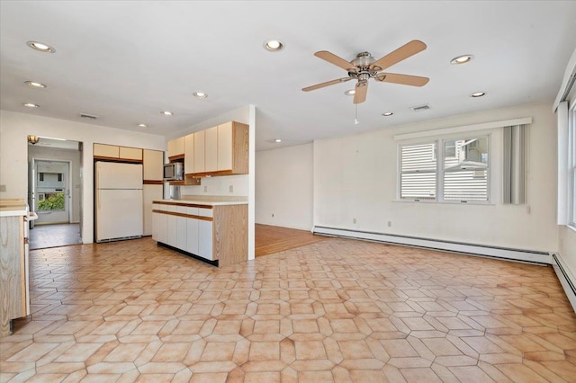 20 Deb St, Plainview, NY 11803 - kitchen featuring freestanding refrigerator, stainless steel microwave, light countertops, baseboard heating, and a ceiling fan