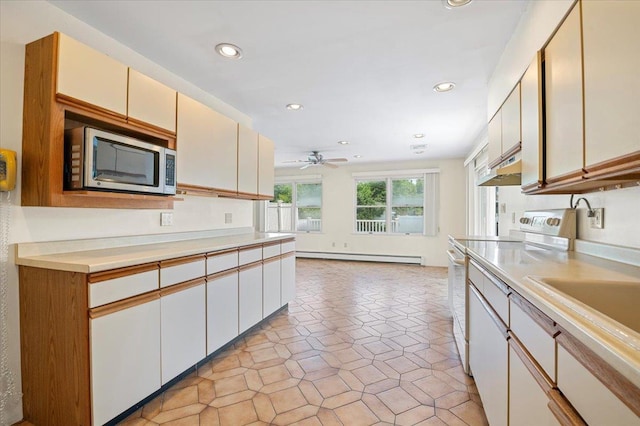 20 Deb St, Plainview, NY 11803 - kitchen with stainless steel microwave, white electric stove, a baseboard heating unit, light countertops, and recessed lighting