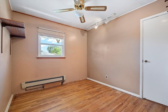 20 Deb St, Plainview, NY 11803 - spare room featuring a baseboard radiator, rail lighting, wood finished floors, a ceiling fan, and ornamental molding