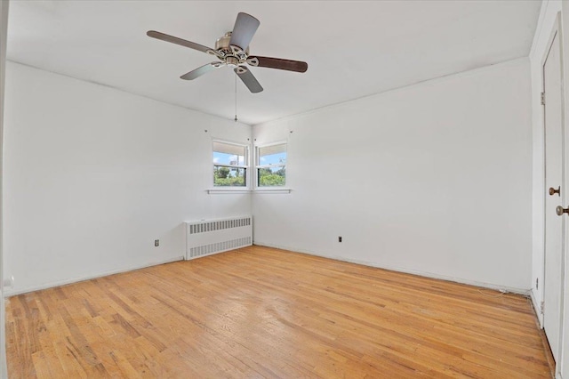 20 Deb St, Plainview, NY 11803 - unfurnished room with radiator, light wood-style flooring, and a ceiling fan