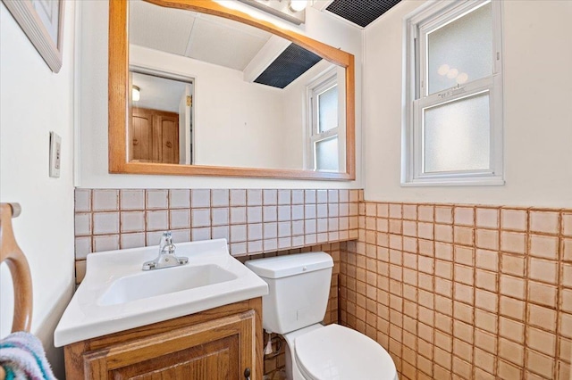 20 Deb St, Plainview, NY 11803 - bathroom with tile walls, vanity, and a wainscoted wall