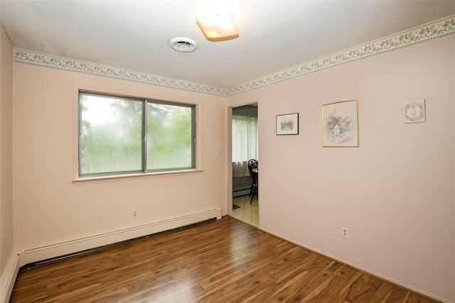 180 Hunter Ave, North Babylon, NY 11703 - empty room featuring baseboard heating, wood finished floors, and a baseboard heating unit