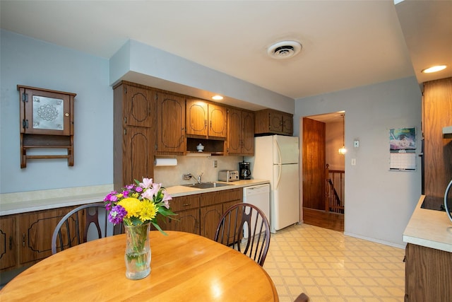 180 Hunter Ave, North Babylon, NY 11703 - kitchen featuring white appliances, light countertops, light flooring, tasteful backsplash, and brown cabinets