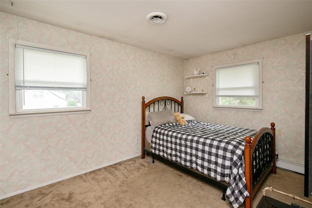 180 Hunter Ave, North Babylon, NY 11703 - bedroom featuring multiple windows, a baseboard heating unit, carpet flooring, and wallpapered walls