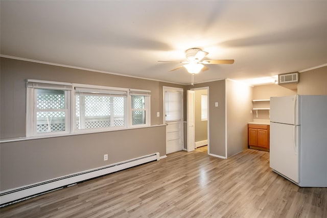 180 Hunter Ave, North Babylon, NY 11703 - unfurnished bedroom with freestanding refrigerator, a baseboard radiator, light wood finished floors, crown molding, and a ceiling fan