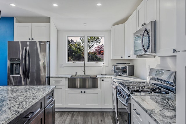 15 Aron Dr, Bohemia, NY 11716 - kitchen featuring stainless steel appliances, light wood-type flooring, white cabinets, and recessed lighting