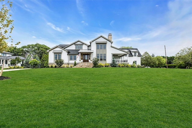 52 Concourse E, Brightwaters, NY 11718 - view of front facade with a chimney and a front lawn