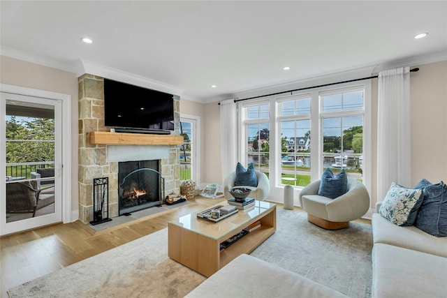 52 Concourse E, Brightwaters, NY 11718 - living area with crown molding, wood finished floors, healthy amount of natural light, a stone fireplace, and recessed lighting