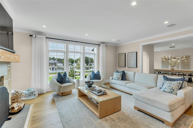 52 Concourse E, Brightwaters, NY 11718 - living room featuring crown molding, a chandelier, light wood finished floors, recessed lighting, and a stone fireplace