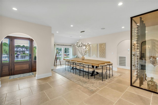 52 Concourse E, Brightwaters, NY 11718 - dining room featuring arched walkways, recessed lighting, and a chandelier