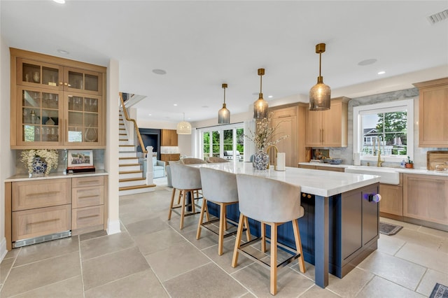 52 Concourse E, Brightwaters, NY 11718 - kitchen featuring healthy amount of natural light, backsplash, light brown cabinets, and recessed lighting