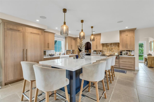 52 Concourse E, Brightwaters, NY 11718 - kitchen featuring custom range hood, backsplash, light brown cabinetry, healthy amount of natural light, and recessed lighting