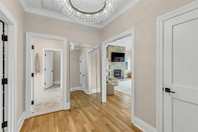 52 Concourse E, Brightwaters, NY 11718 - hall with ornamental molding, light wood-style floors, and a chandelier