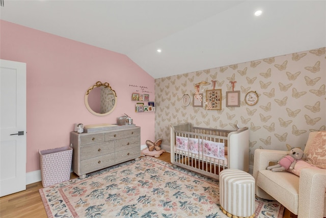 52 Concourse E, Brightwaters, NY 11718 - bedroom with vaulted ceiling, wallpapered walls, recessed lighting, wood finished floors, and a crib