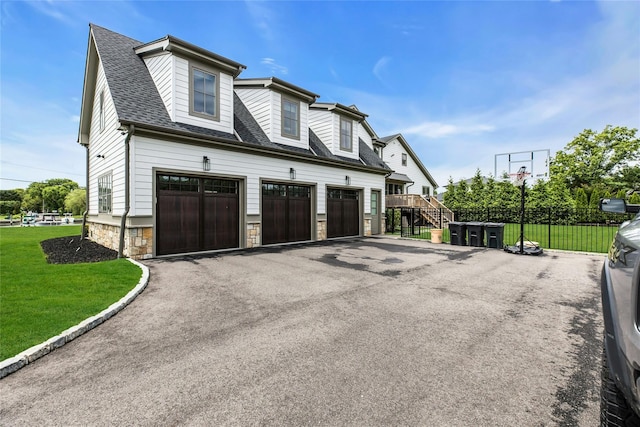 52 Concourse E, Brightwaters, NY 11718 - view of side of home with driveway, a garage, stone siding, and roof with shingles