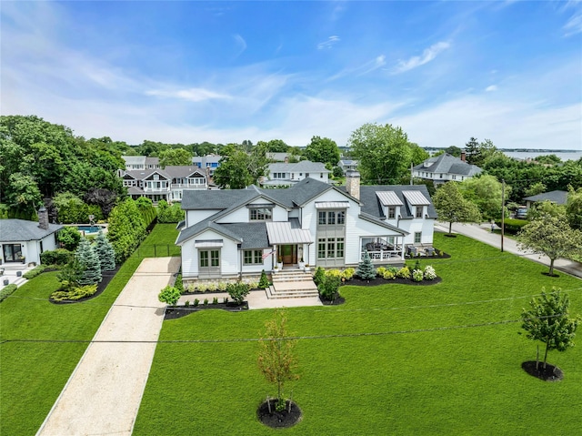 52 Concourse E, Brightwaters, NY 11718 - view of front of home featuring a standing seam roof, a metal roof, and a residential view