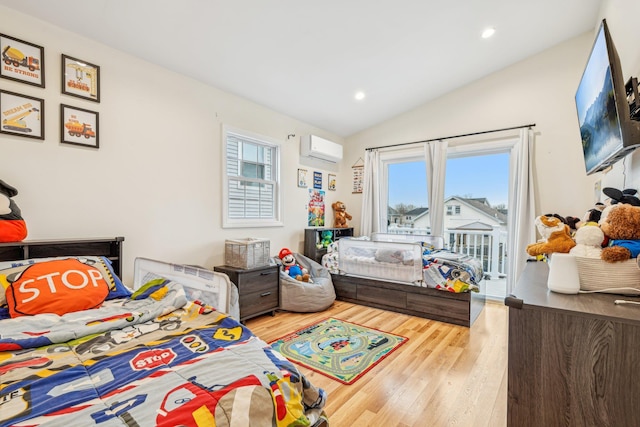 652 Arthur St, Baldwin Harbor, NY 11510 - bedroom with a wall mounted AC, vaulted ceiling, wood finished floors, access to exterior, and recessed lighting
