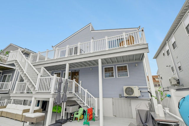 652 Arthur St, Baldwin Harbor, NY 11510 - rear view of house with stairway and a wooden deck
