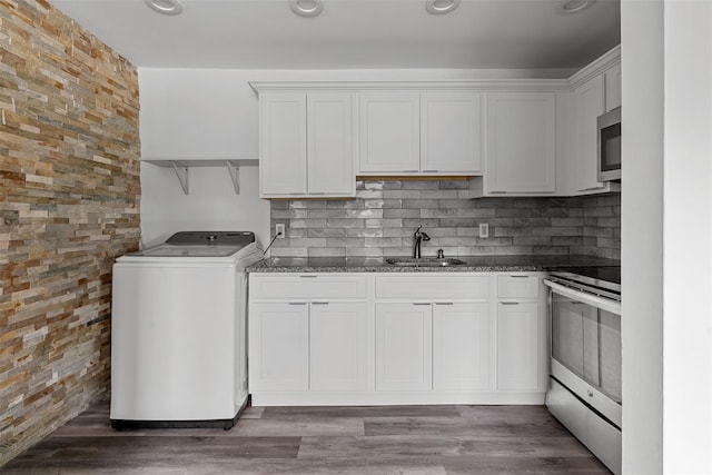 14 E White Gate Rd, Wappingers Falls, NY 12590 - kitchen with washer / clothes dryer, stainless steel appliances, white cabinetry, and dark stone countertops
