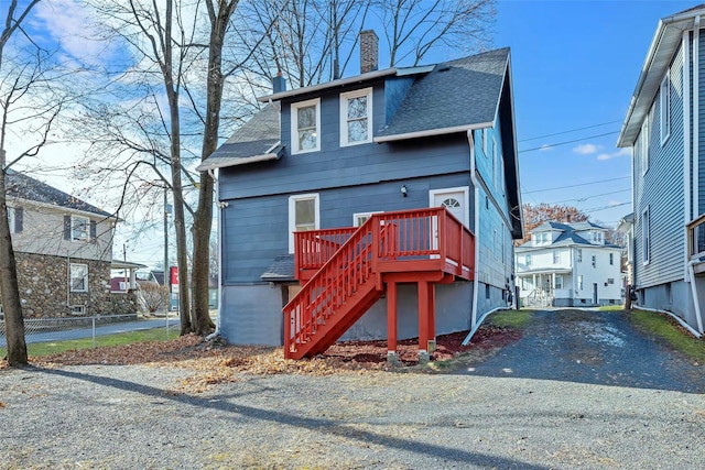 111/2 Dolson Ave, Middletown, NY 10940 - view of front facade featuring roof with shingles, a chimney, stairs, a deck, and a residential view