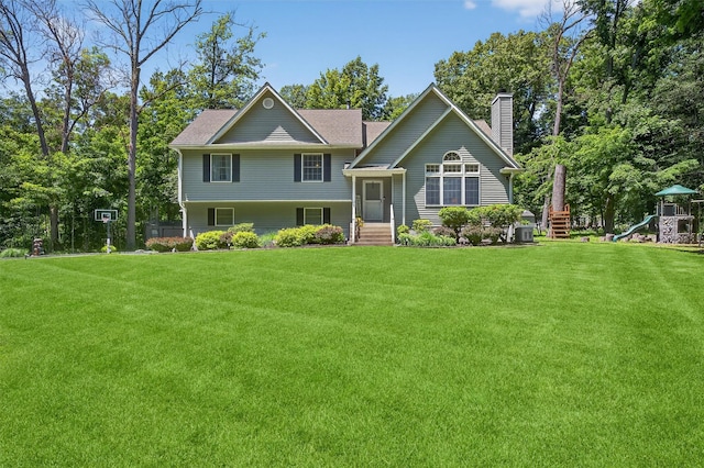 311 Myers Corners Rd, Wappingers Falls, NY 12590 - view of front of property featuring a chimney, a front lawn, a playground, and roof with shingles