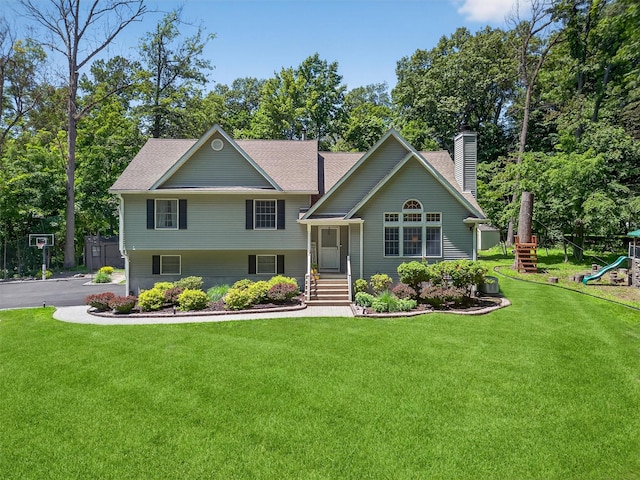 311 Myers Corners Rd, Wappingers Falls, NY 12590 - split level home featuring a chimney, a front yard, a playground, and roof with shingles