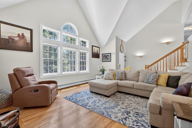 311 Myers Corners Rd, Wappingers Falls, NY 12590 - living area with a baseboard radiator, wood finished floors, high vaulted ceiling, and stairs