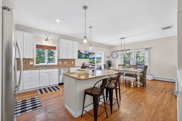 311 Myers Corners Rd, Wappingers Falls, NY 12590 - kitchen featuring appliances with stainless steel finishes, white cabinets, backsplash, healthy amount of natural light, and recessed lighting