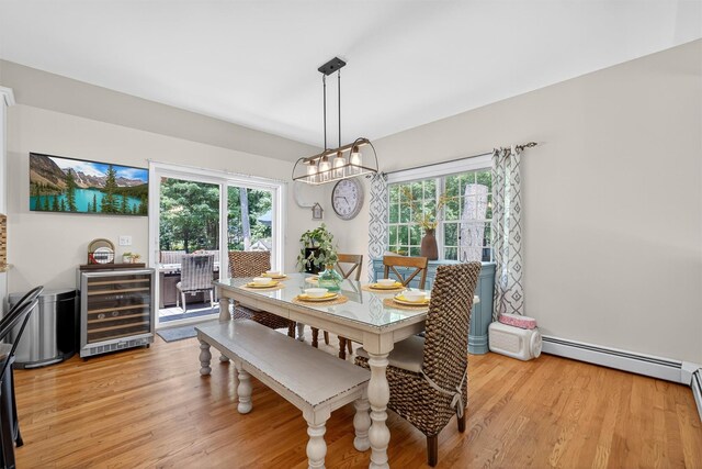 311 Myers Corners Rd, Wappingers Falls, NY 12590 - dining area featuring beverage cooler, a baseboard heating unit, healthy amount of natural light, and light wood-style flooring