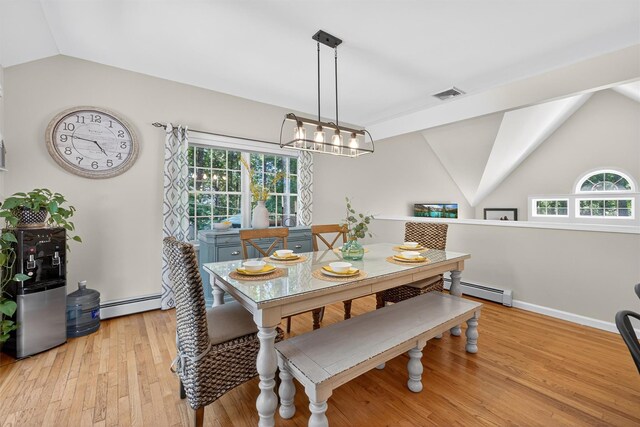 311 Myers Corners Rd, Wappingers Falls, NY 12590 - dining space with lofted ceiling, healthy amount of natural light, a baseboard heating unit, and light wood-type flooring