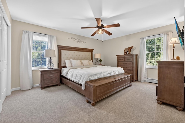 311 Myers Corners Rd, Wappingers Falls, NY 12590 - bedroom featuring multiple windows, a baseboard heating unit, light carpet, and ceiling fan