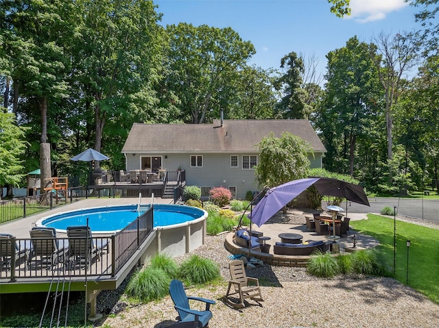 311 Myers Corners Rd, Wappingers Falls, NY 12590 - view of swimming pool with a deck, a fire pit, a patio area, and view of wooded area