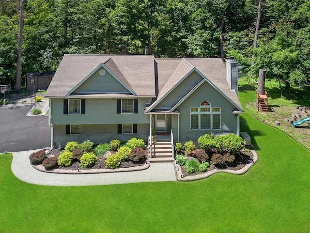 311 Myers Corners Rd, Wappingers Falls, NY 12590 - view of front of property with a chimney, a front yard, a playground, and roof with shingles
