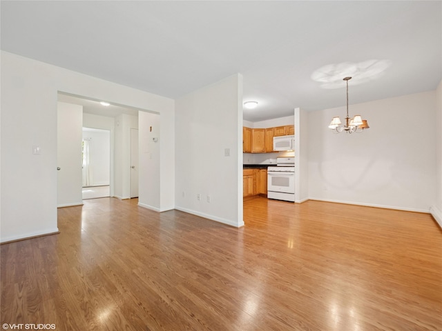 4H Locust Ct Unit H, Fishkill, NY 12524 - unfurnished living room with a chandelier and light wood-type flooring