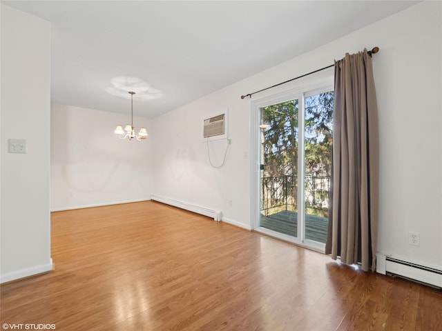 4H Locust Ct Unit H, Fishkill, NY 12524 - spare room featuring baseboard heating, wood finished floors, a chandelier, a wall unit AC, and a baseboard radiator