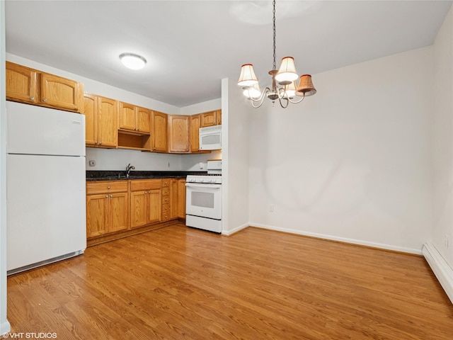 4H Locust Ct Unit H, Fishkill, NY 12524 - kitchen featuring white appliances, dark countertops, light wood-type flooring, a chandelier, and pendant lighting