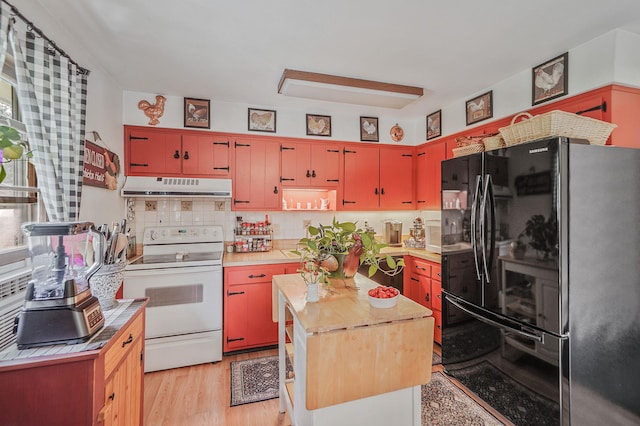 12 Pine Cone St, Middle Island, NY 11953 - kitchen featuring freestanding refrigerator, white electric stove, extractor fan, red cabinets, and tasteful backsplash