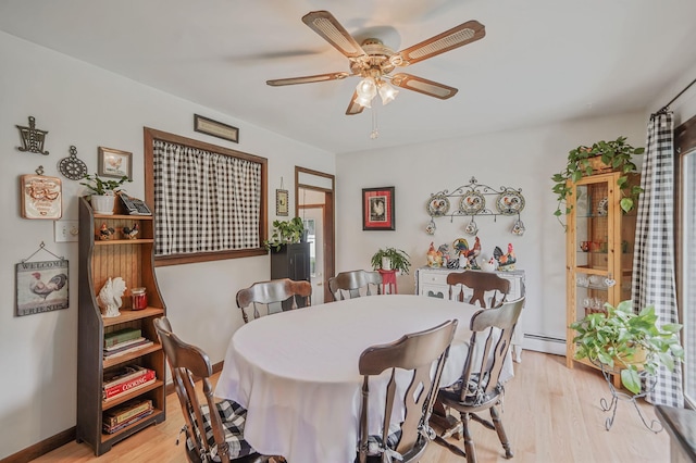 12 Pine Cone St, Middle Island, NY 11953 - dining area with light wood-type flooring, ceiling fan, and a baseboard heating unit