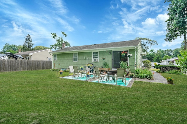 12 Pine Cone St, Middle Island, NY 11953 - back of property with a patio area and a chimney
