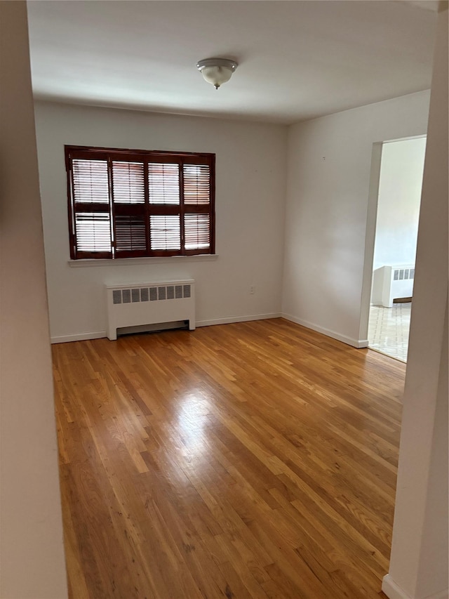 68 Loring Ave, Yonkers, NY 10704 - unfurnished room featuring radiator heating unit and wood finished floors