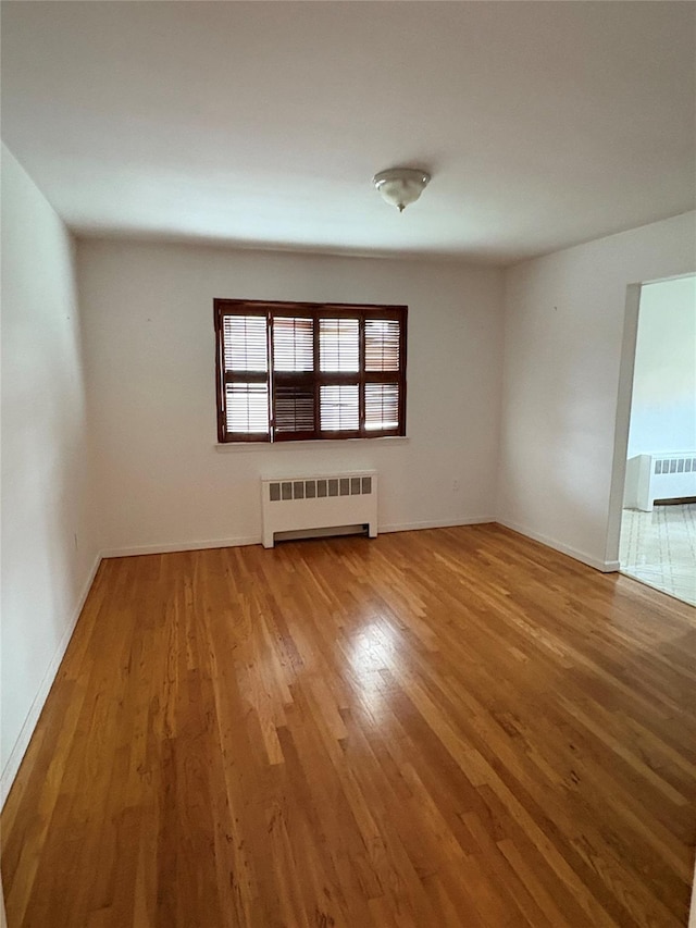 68 Loring Ave, Yonkers, NY 10704 - empty room with radiator heating unit and wood finished floors
