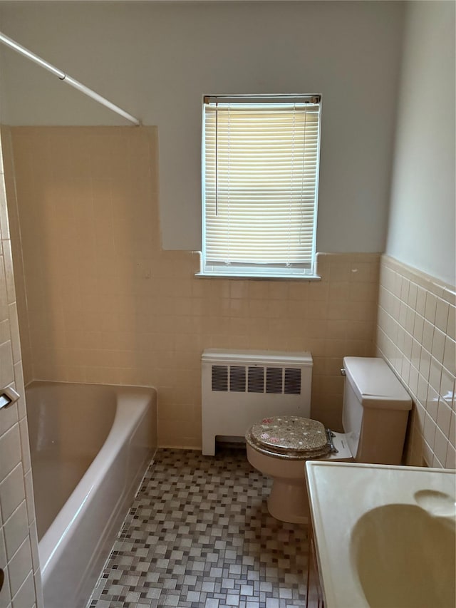 68 Loring Ave, Yonkers, NY 10704 - bathroom with radiator, tile walls, vanity, and wainscoting