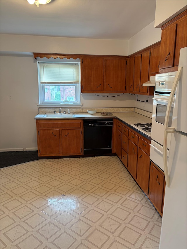 68 Loring Ave, Yonkers, NY 10704 - kitchen featuring white appliances, a warming drawer, under cabinet range hood, and brown cabinetry