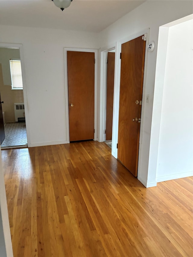 68 Loring Ave, Yonkers, NY 10704 - spare room featuring radiator heating unit and light wood finished floors