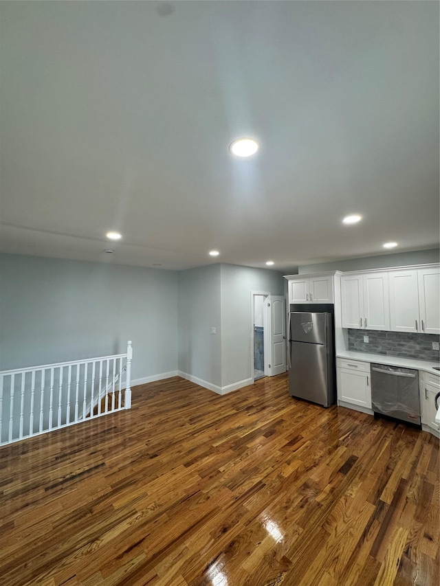 1611 Research Ave, Bronx, NY 10465 - kitchen featuring appliances with stainless steel finishes, recessed lighting, white cabinetry, dark wood-type flooring, and decorative backsplash