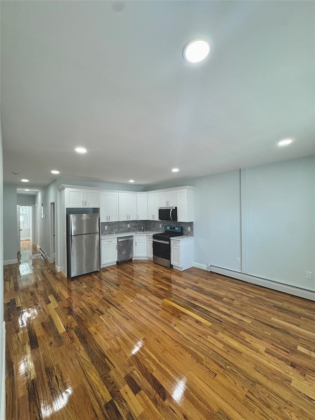 1611 Research Ave, Bronx, NY 10465 - kitchen featuring appliances with stainless steel finishes, white cabinets, backsplash, dark wood-type flooring, and recessed lighting