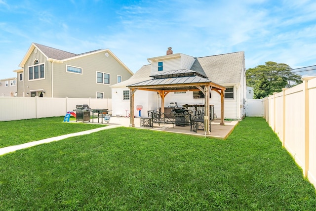 14 Crocus Ct, West Babylon, NY 11704 - rear view of property featuring a gazebo, a patio area, a standing seam roof, a fenced backyard, and a chimney